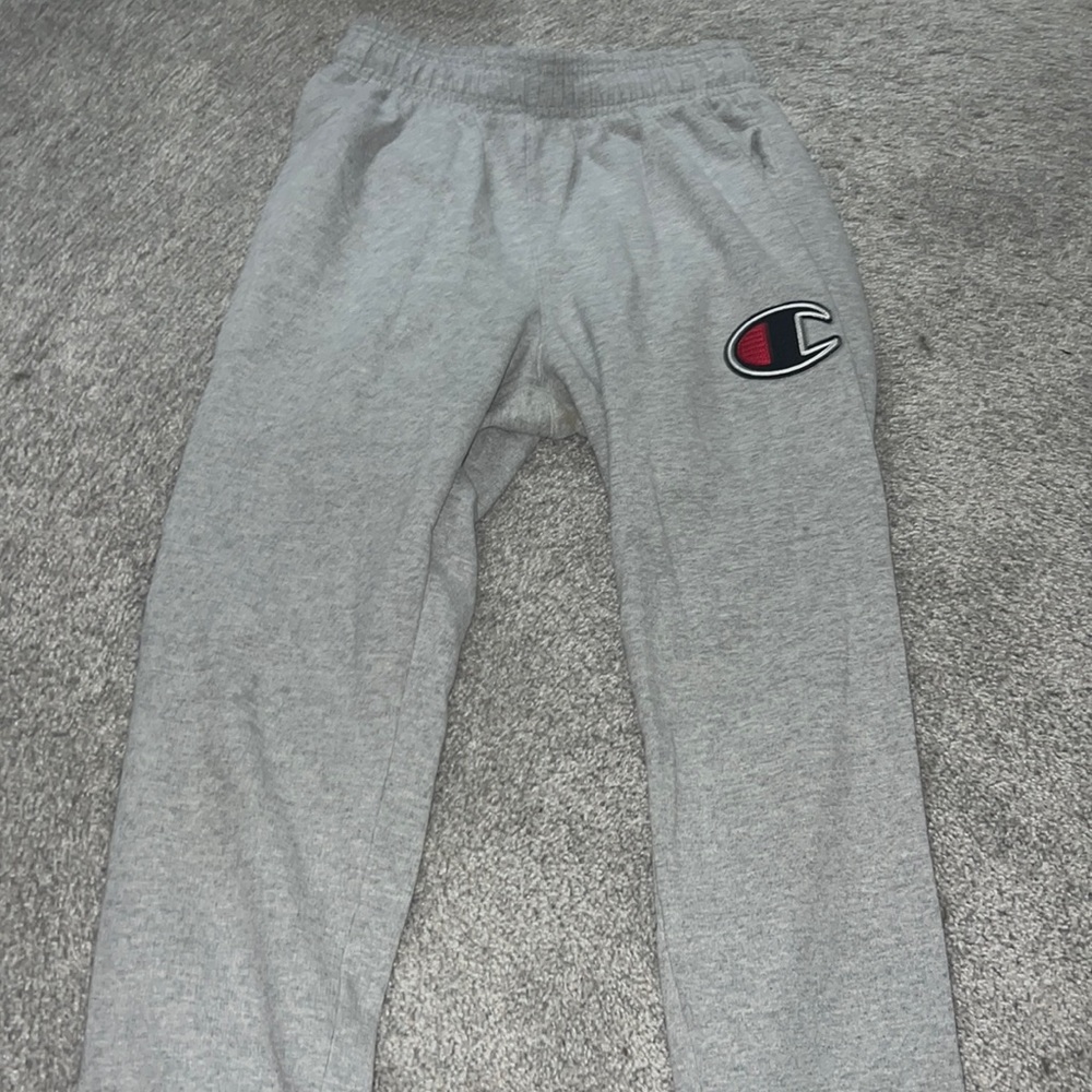 Champion sweatpants size small with printed logo on the front in black and red.